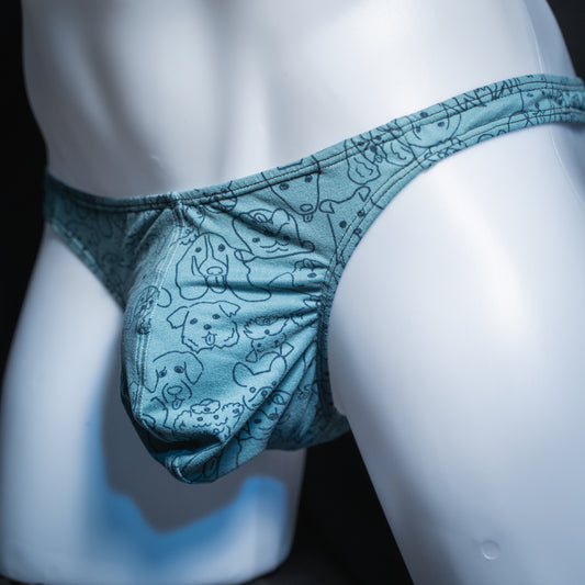 Men's dog faces on blue thong, classic cut, angled front view.