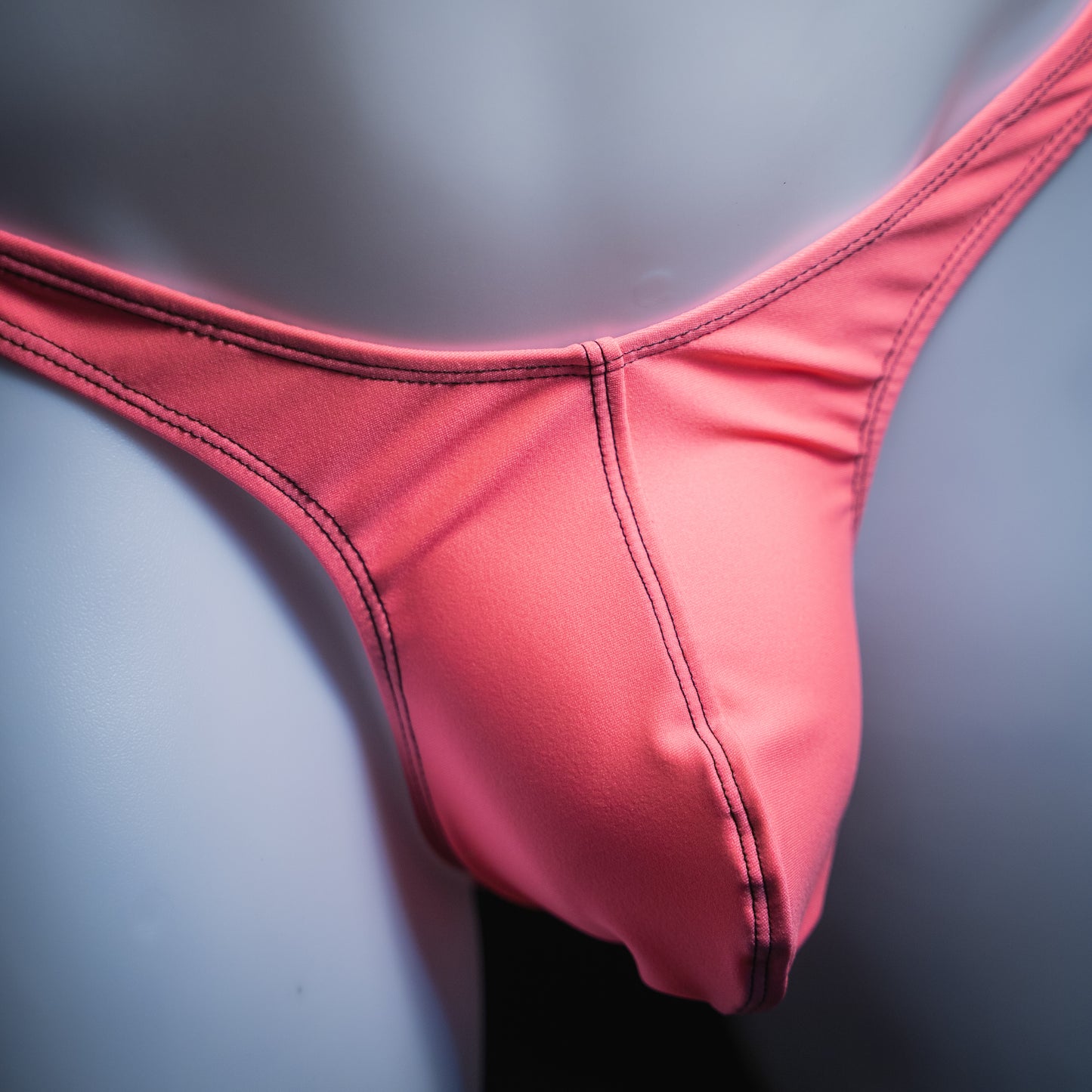 handmade mens thong underwear, flamingo pink print, spandex material, slim cut, close up angled front view