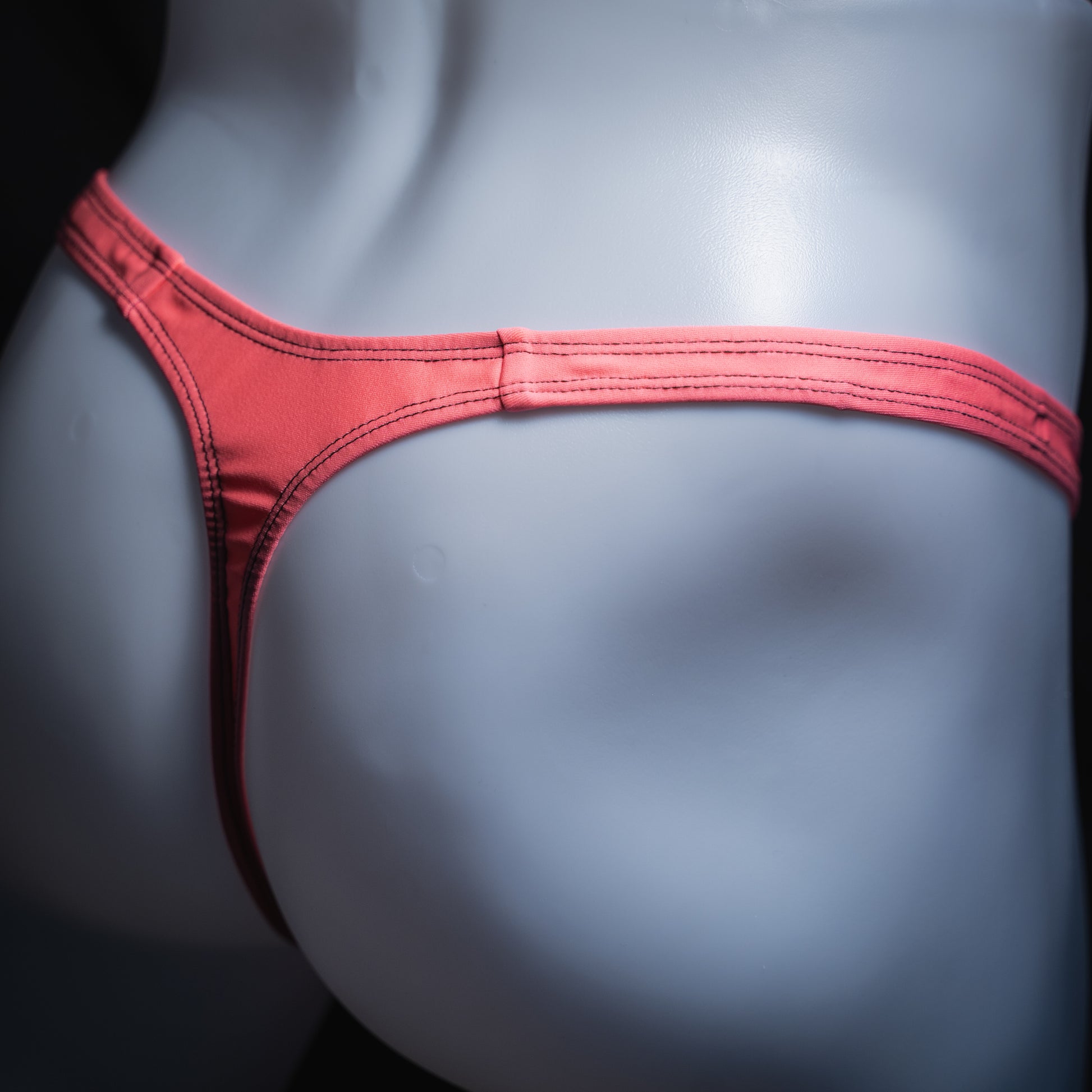handmade mens thong underwear, flamingo pink print, spandex material, slim cut, angled back view