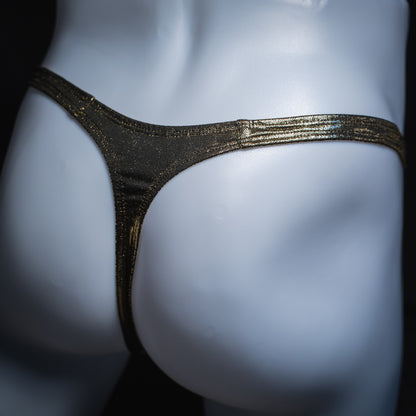 Men's gold metallic thong, slim cut, angled rear view.