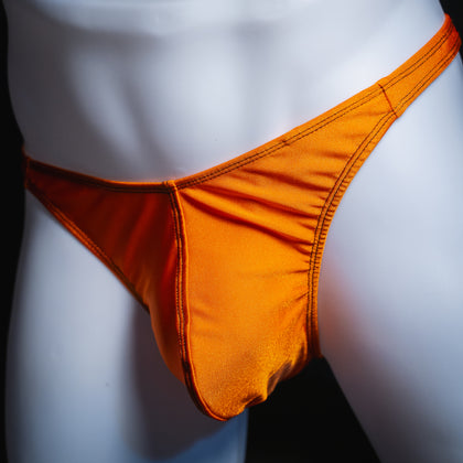 handmade mens thong underwear, solid orange print, spandex material, classic cut variation, angled front view