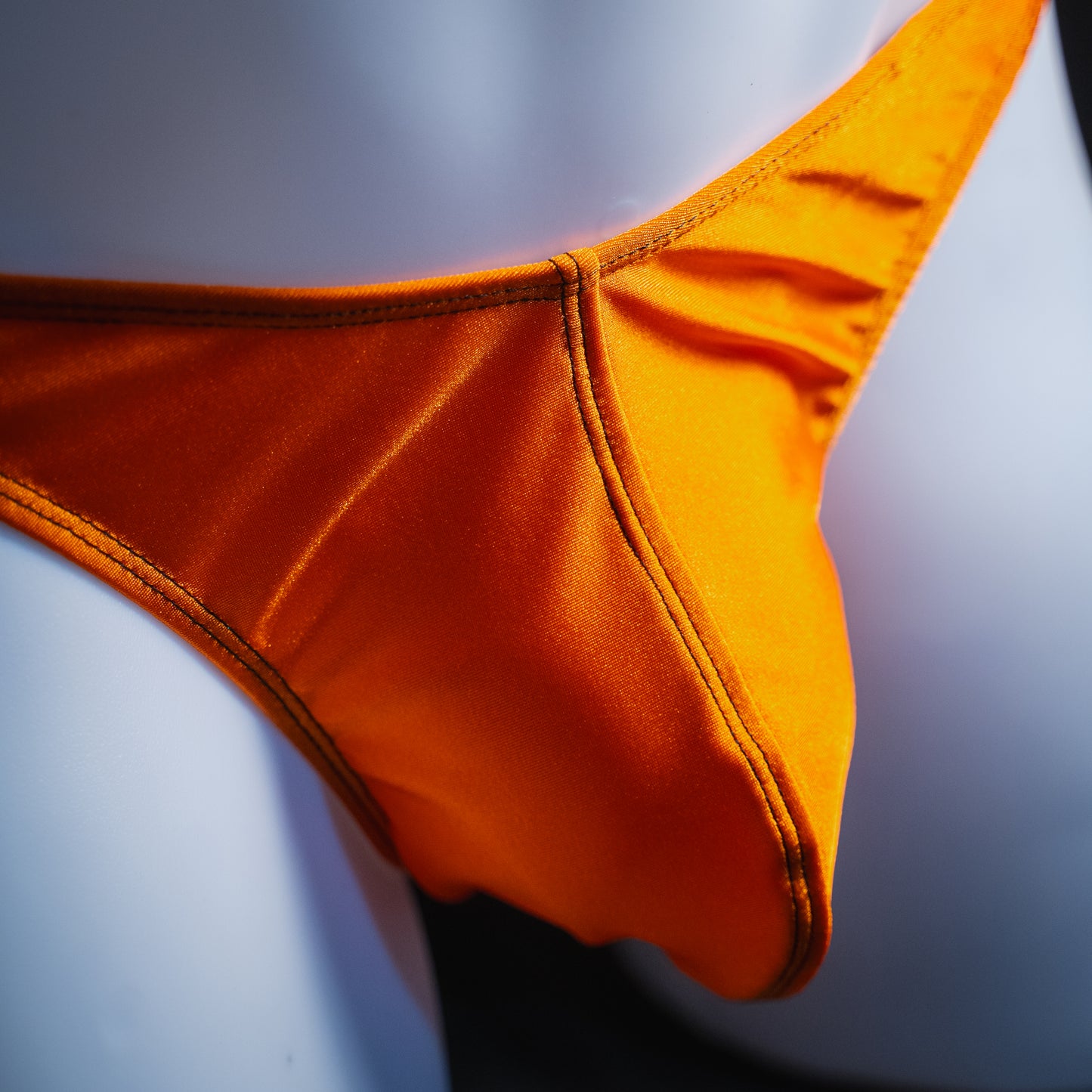 handmade mens thong underwear, solid orange print, spandex material, classic cut variation, close up angled front view