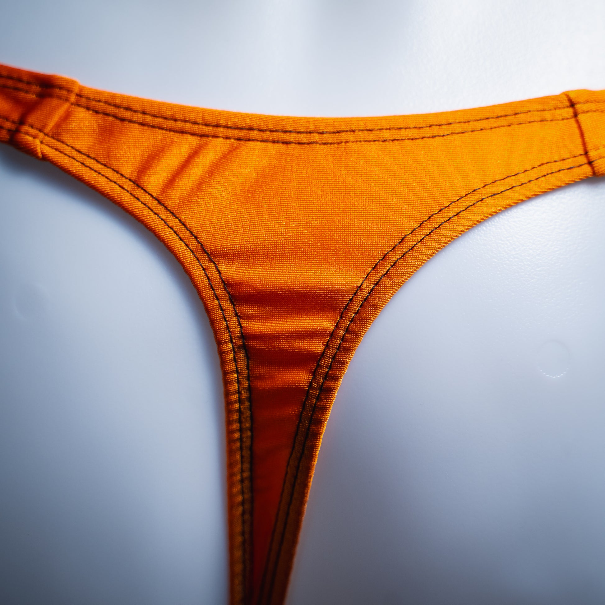handmade mens thong underwear, solid orange print, spandex material, classic cut variation, close up back view