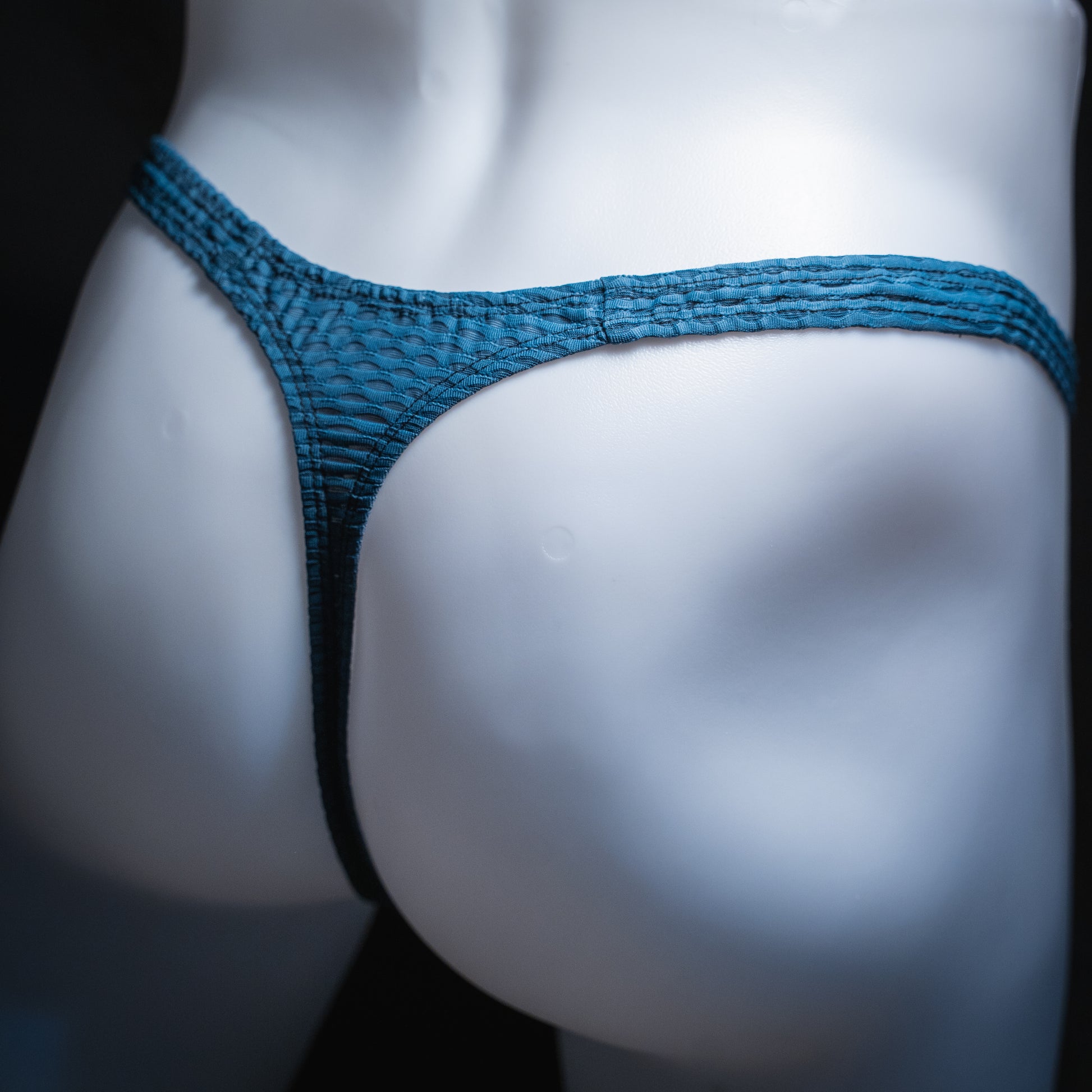 handmade mens thong underwear, blue yoga mesh material, slim cut, angled back view