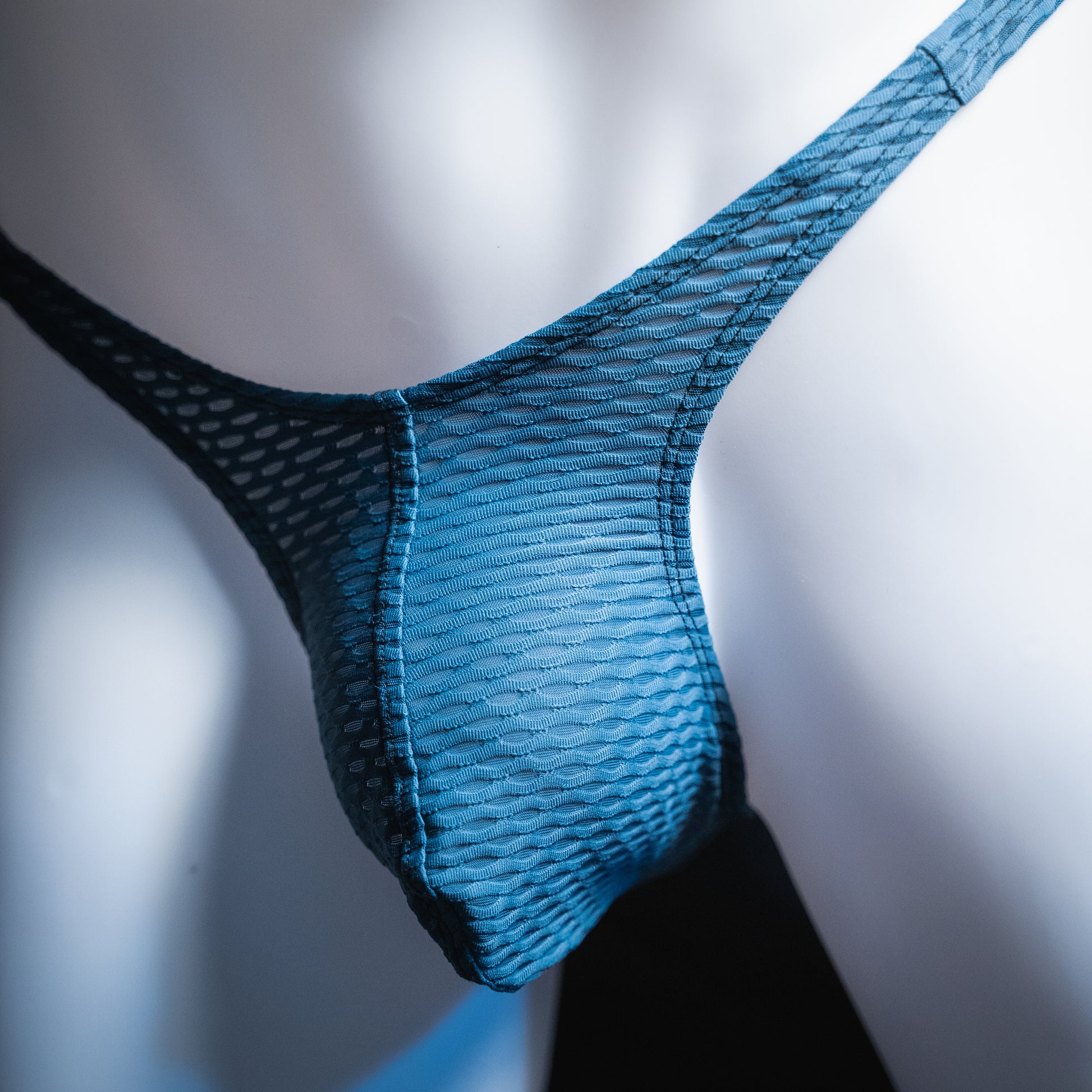 handmade mens thong underwear, blue yoga mesh material, slim cut, angled front view