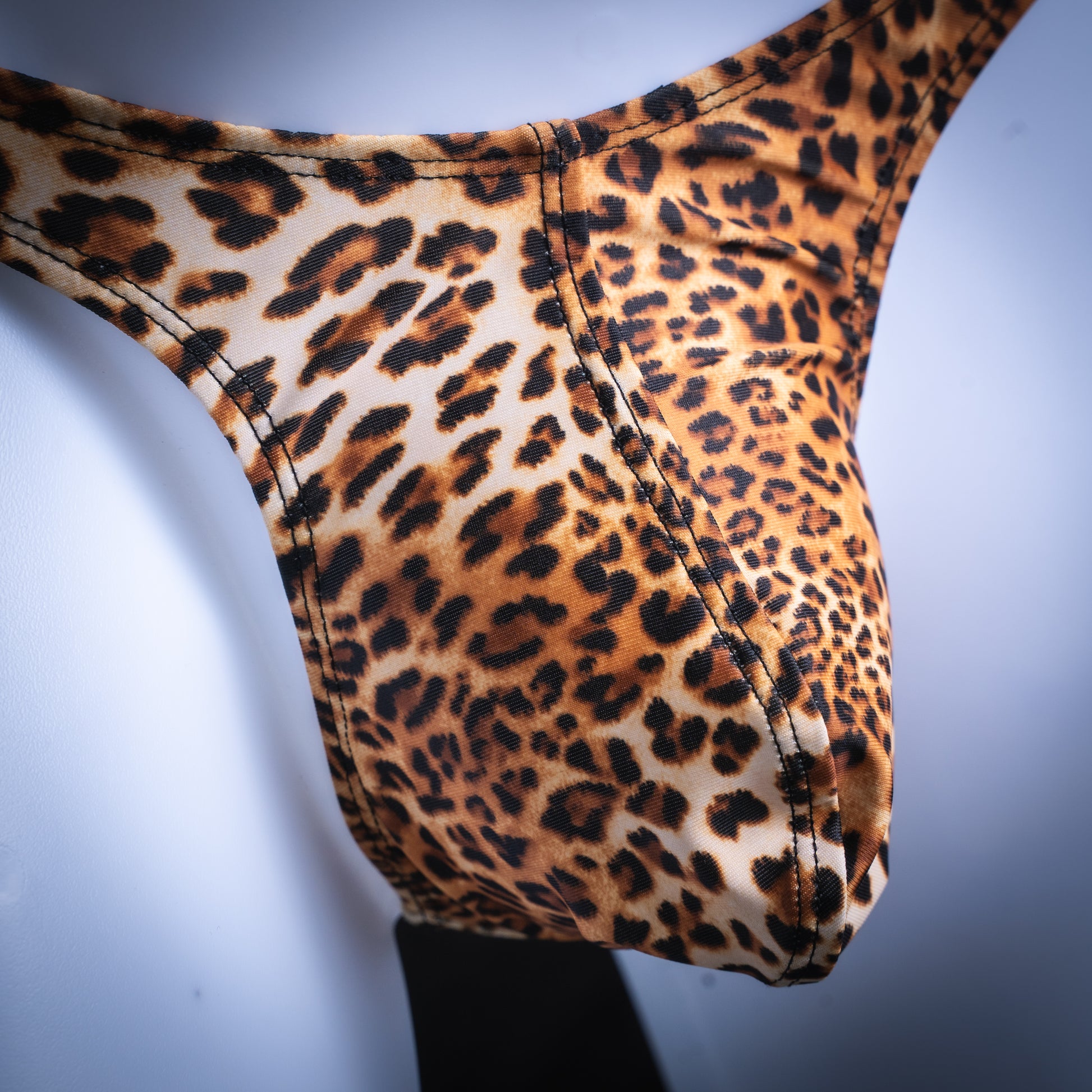 handmade mens thong underwear, leopard print, spandex material, slim cut, close up angled front view