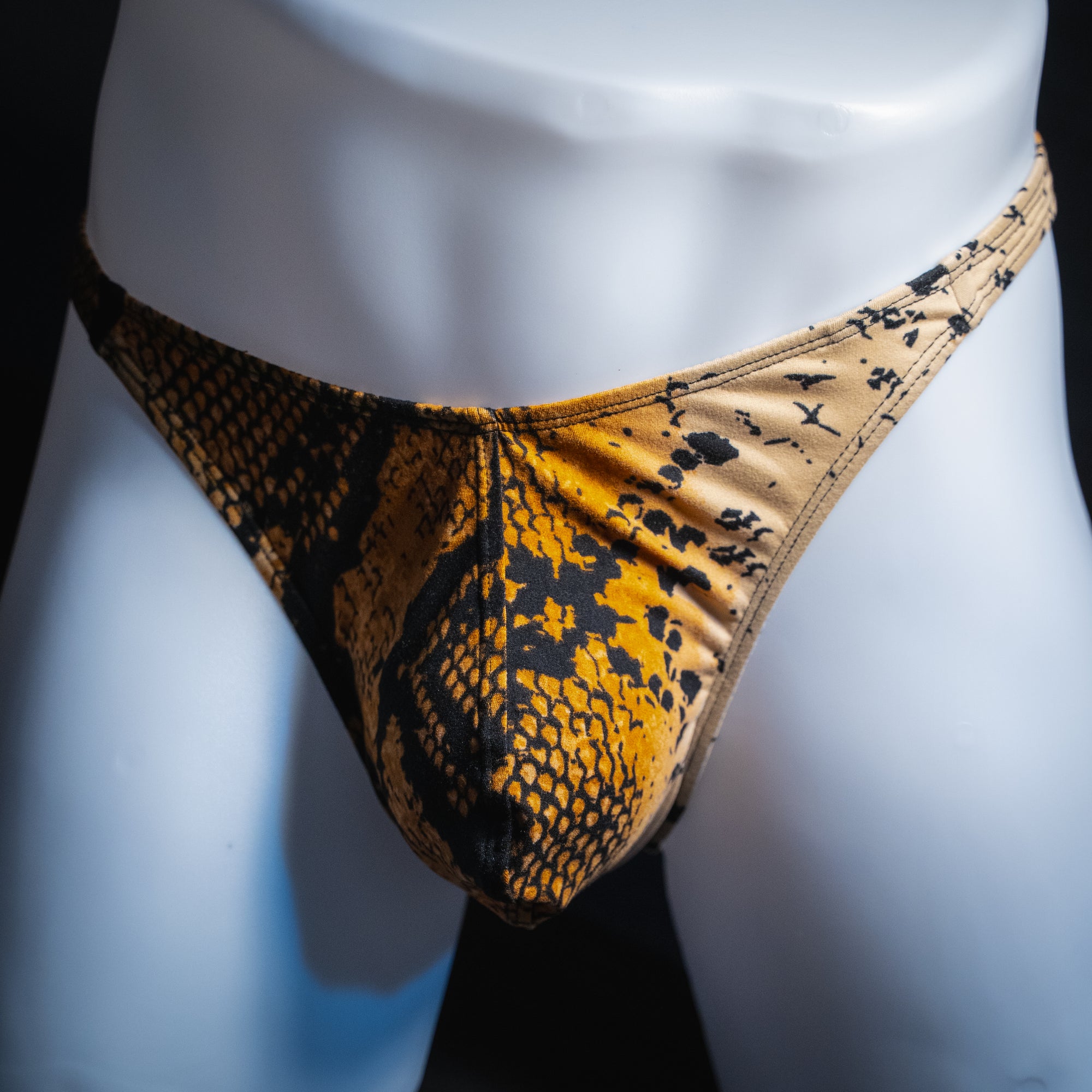 Men's mud snakeskin thong, classic cut, front view.