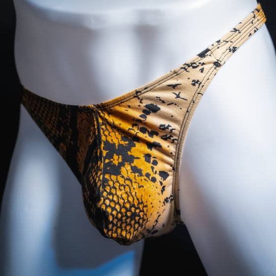 Men's mud snakeskin thong, classic cut, angled front view.