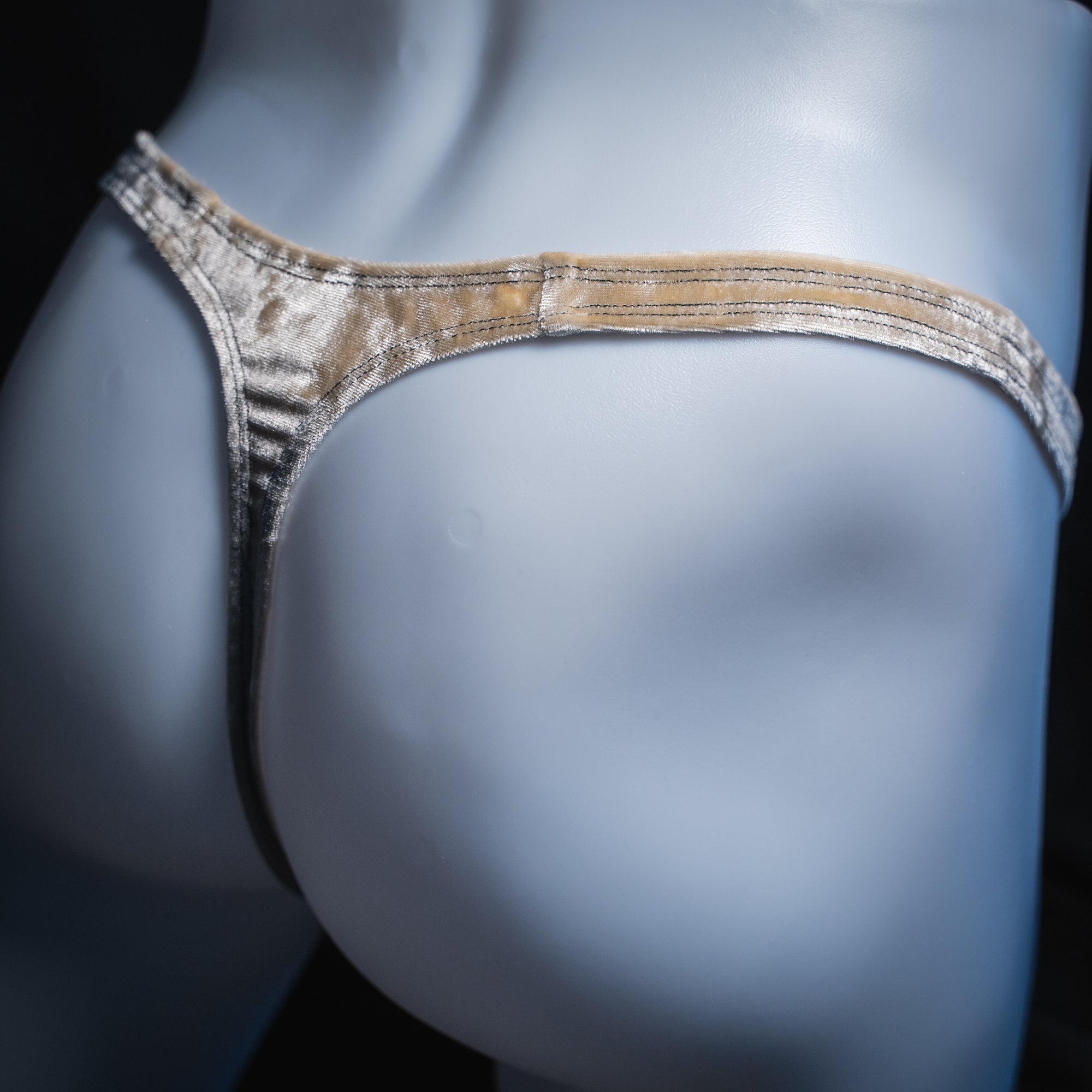 Men's pearl velvet thong, slim cut, angled rear view.