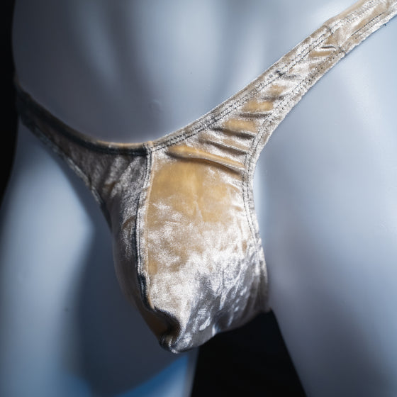 Men's pearl velvet thong, slim cut, angled front view.