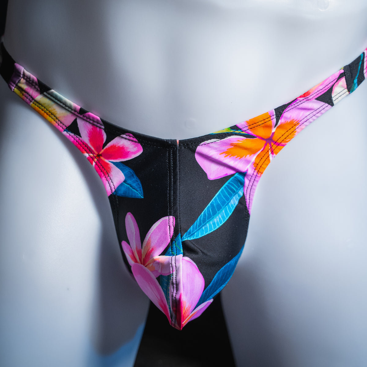 Men's pink floral thong, slim cut, front view.