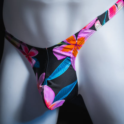 Men's pink floral thong, slim cut, angled front view.