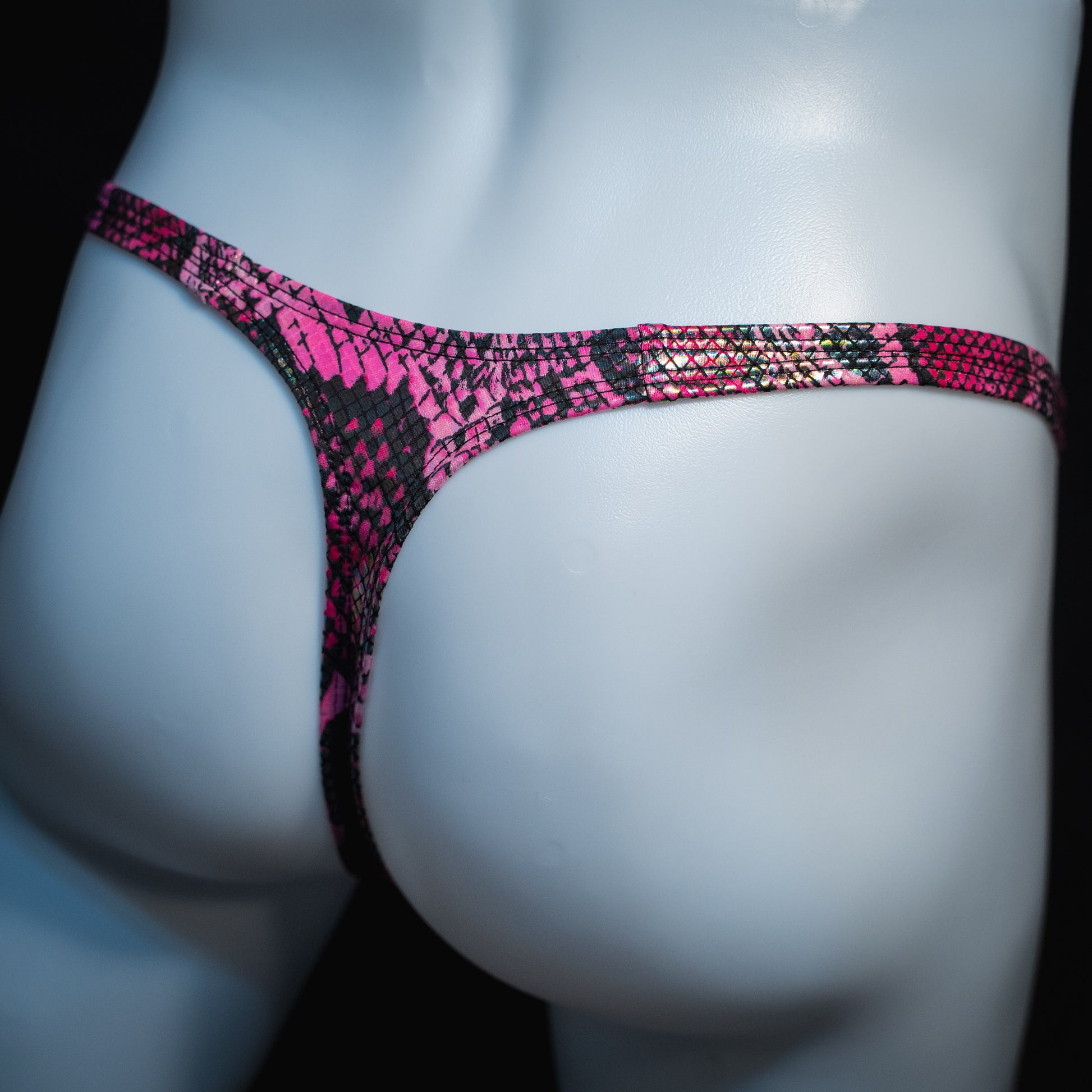 Men's pink metallic snakeskin-print thong underwear, classic cut, back angled view.