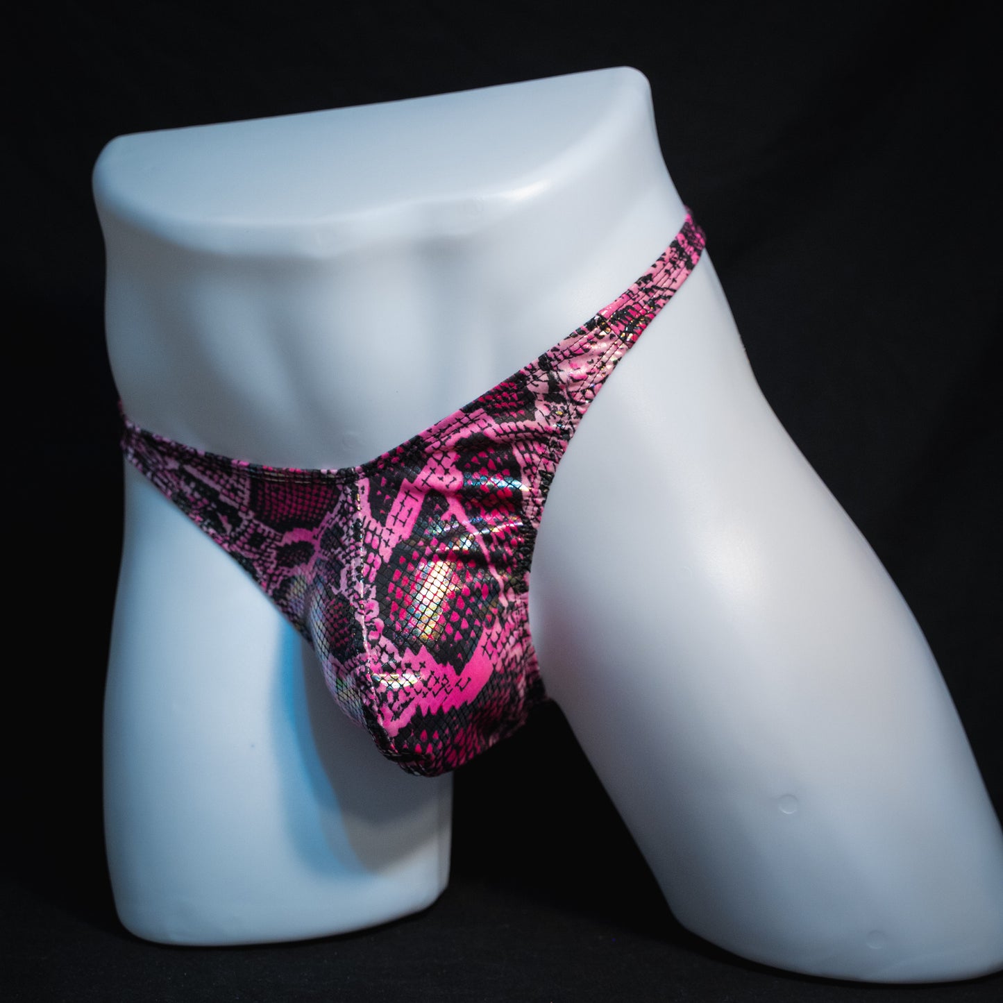 Men's pink metallic snakeskin-print thong underwear, classic cut, full front view angled.