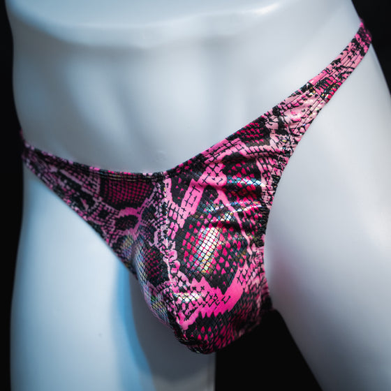 Men's pink metallic snakeskin-print thong underwear, classic cut, angled front view.