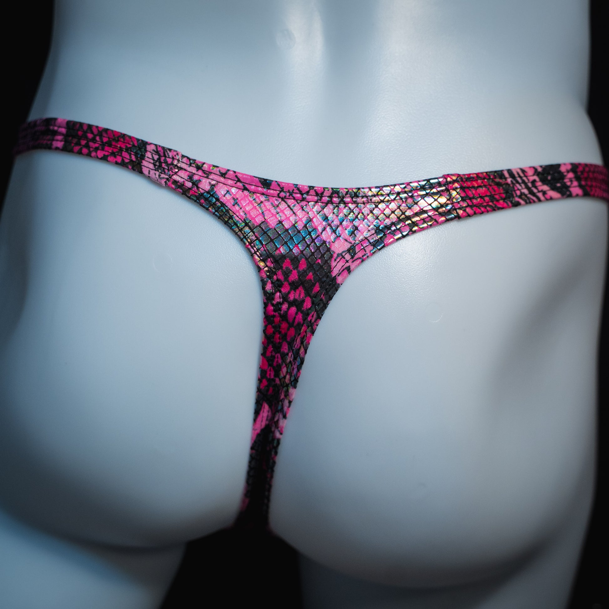 Men's pink metallic snakeskin-print thong underwear, classic cut, back view.
