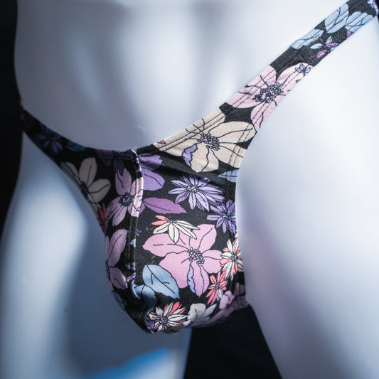 Men's purple floral thong, slim cut, angled front view.