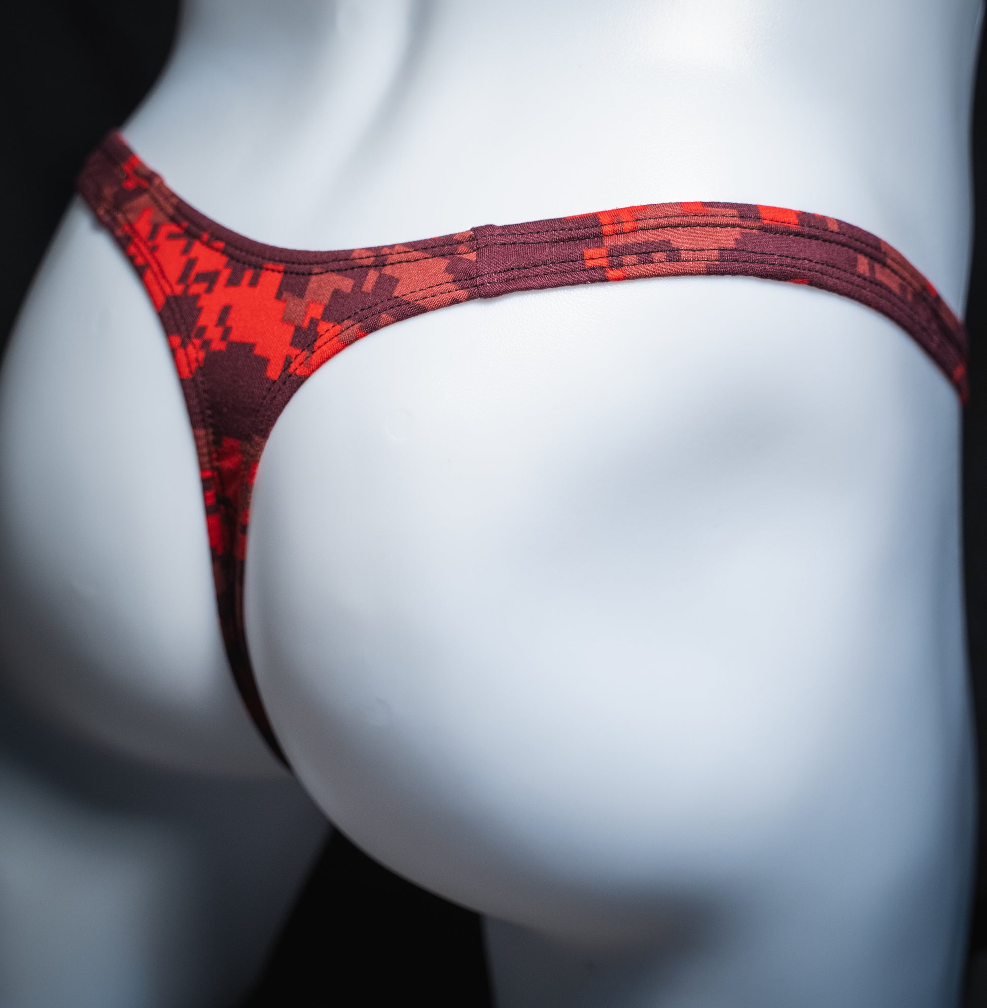 handmade mens thong underwear, red digital camo print, soft polyester material, slim cut variation, angled back view