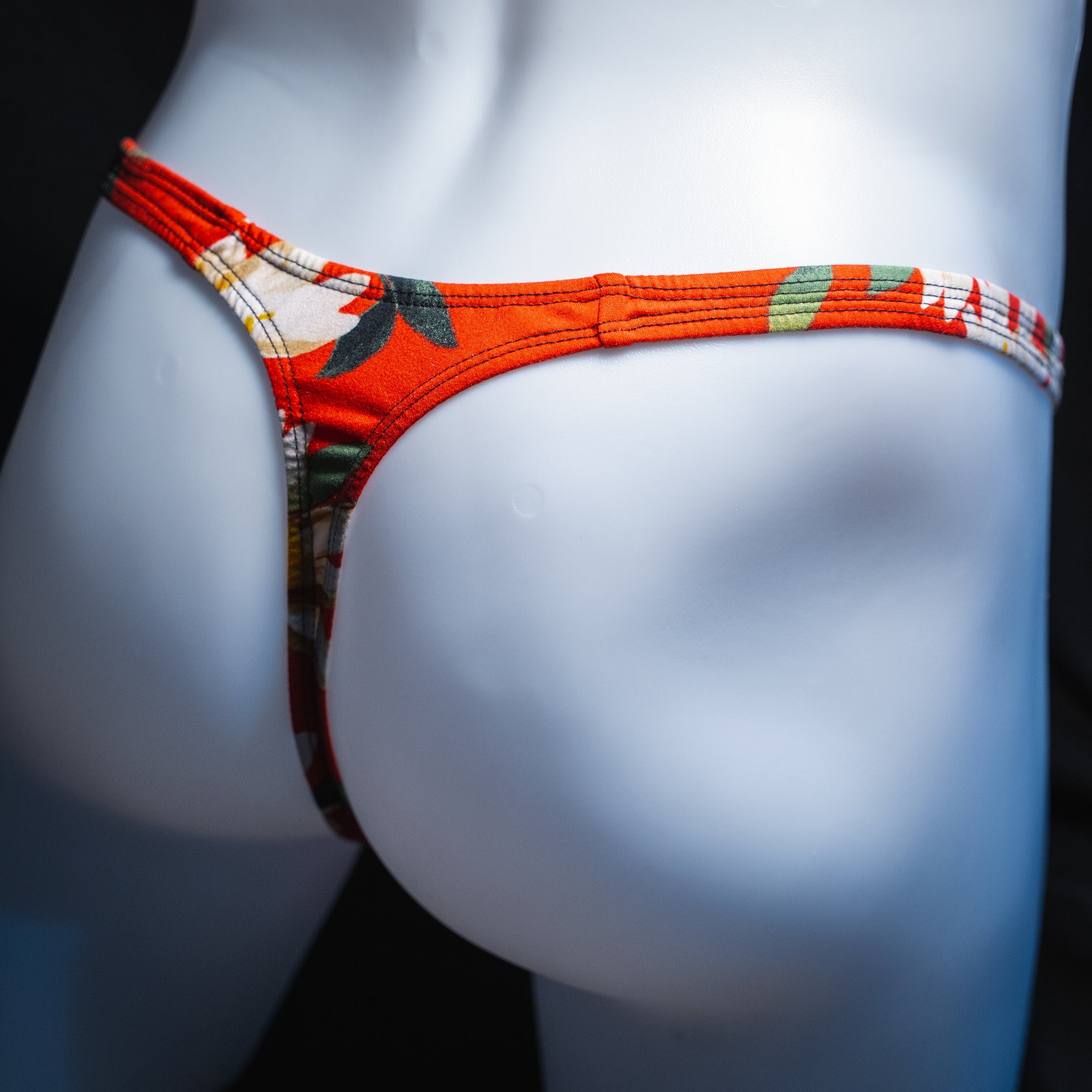 handmade mens thong underwear, red floral print, soft polyester material, slim cut variation, angled back view