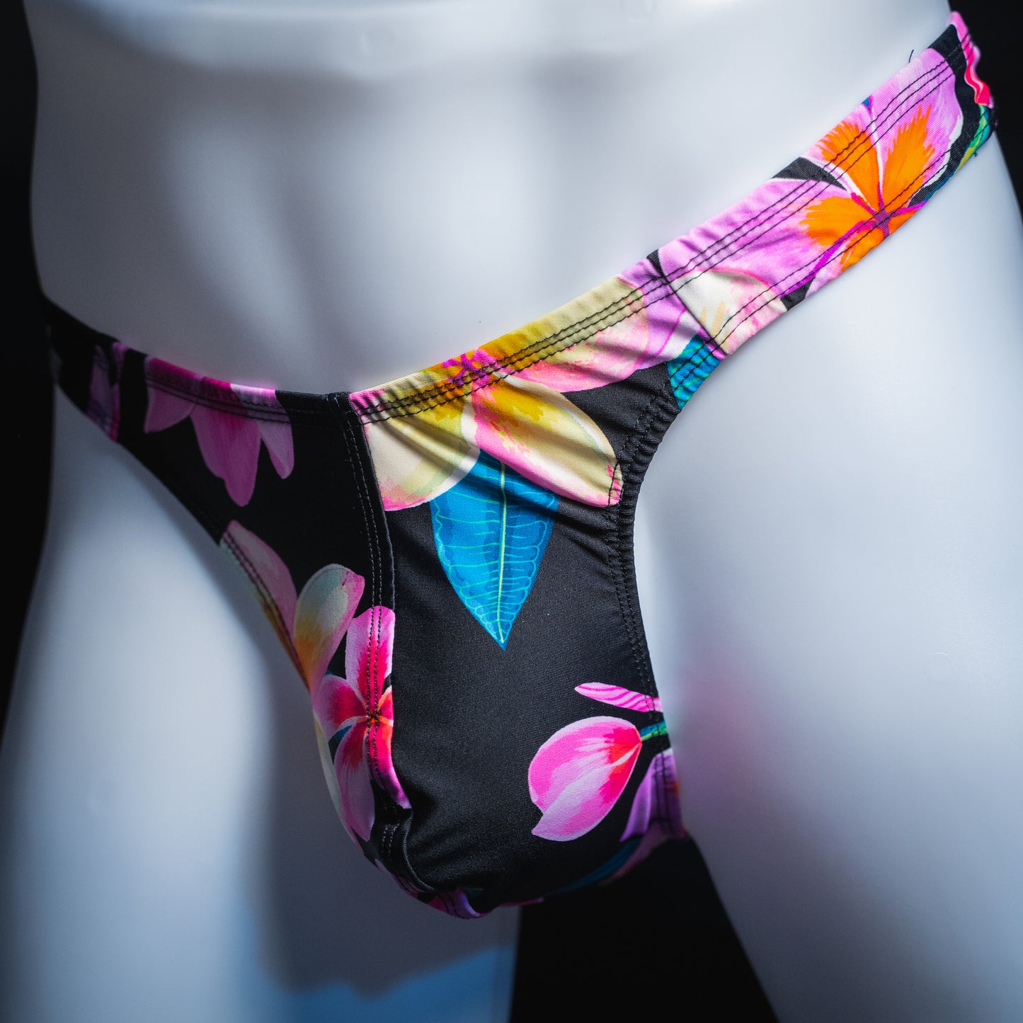 handmade mens thong underwear, pink floral pattern, spandex material, robust cut design, angled front view