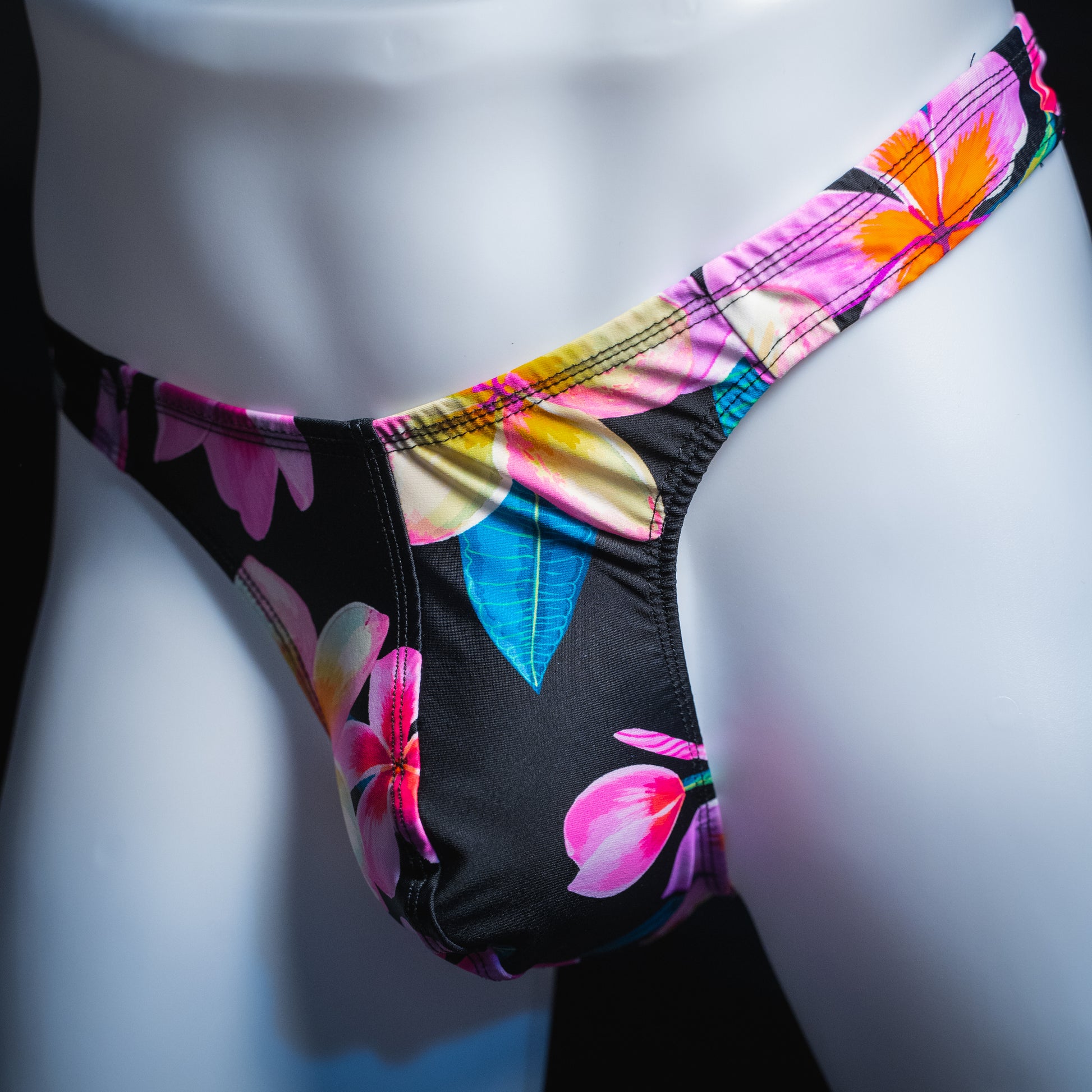 handmade mens thong underwear, pink floral pattern, spandex material, robust cut design, angled front view