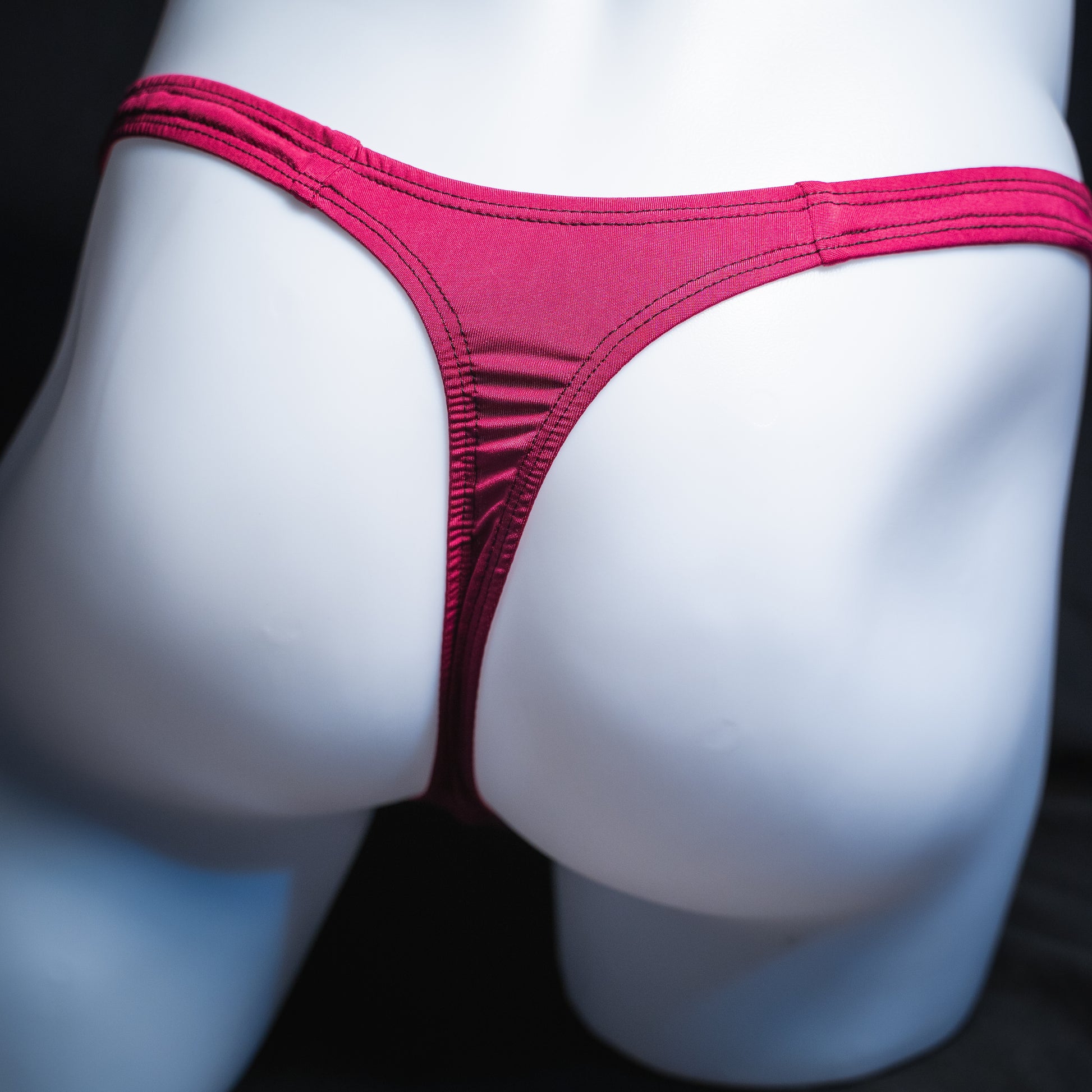 Men's silky maroon thong, classic cut, rear view.