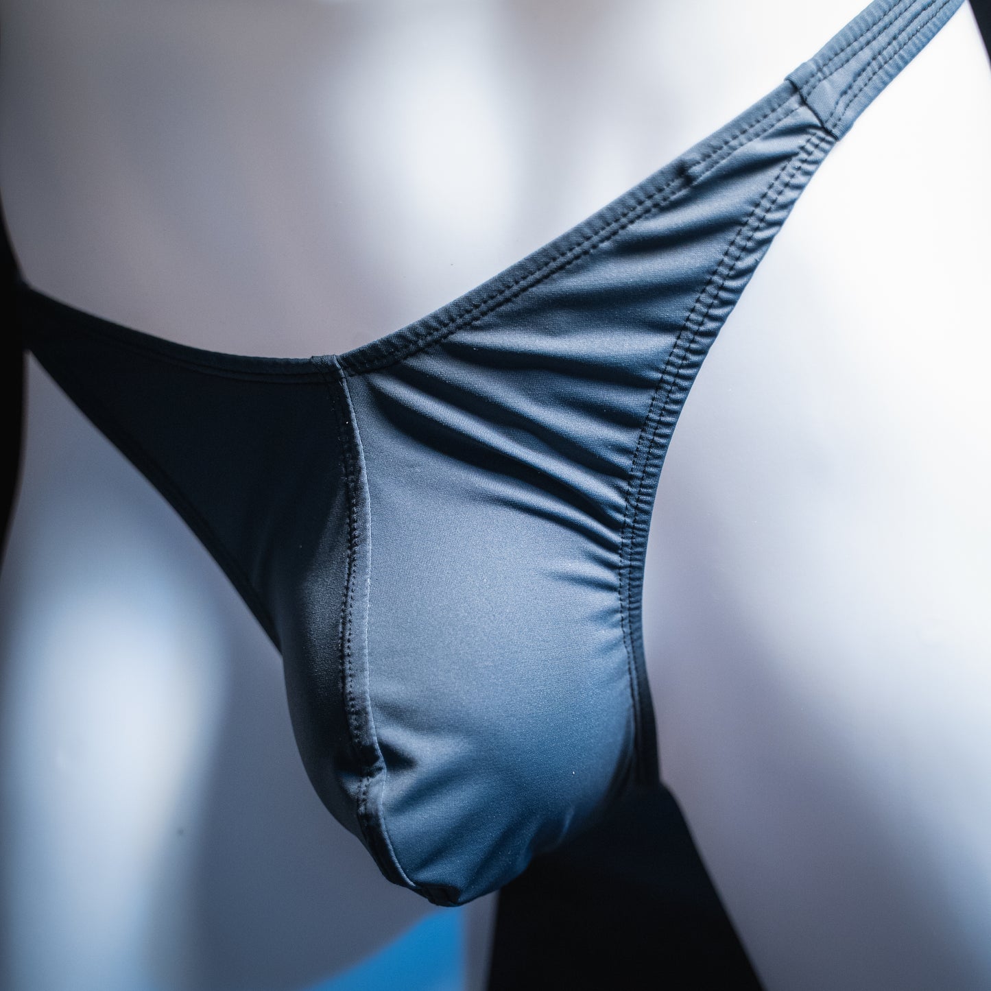 handmade mens thong underwear, solid gray print, spandex material, classic cut variation, angled front view