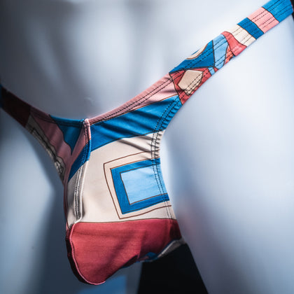 Men's abstract art deco thong, slim cut, angled front view.