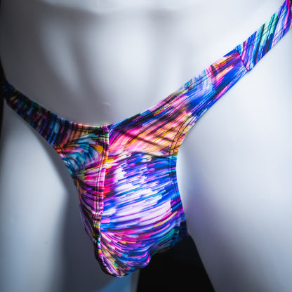 Men's colorful light trails thong, slim cut, angled front view.