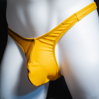 Men's solid golden yellow thong, slim cut, angled front view.