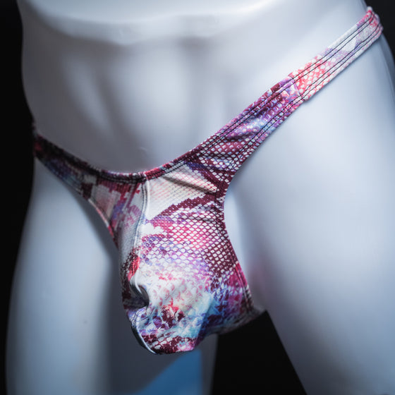 Men's pink snakeskin thong, slim cut, angled front view.
