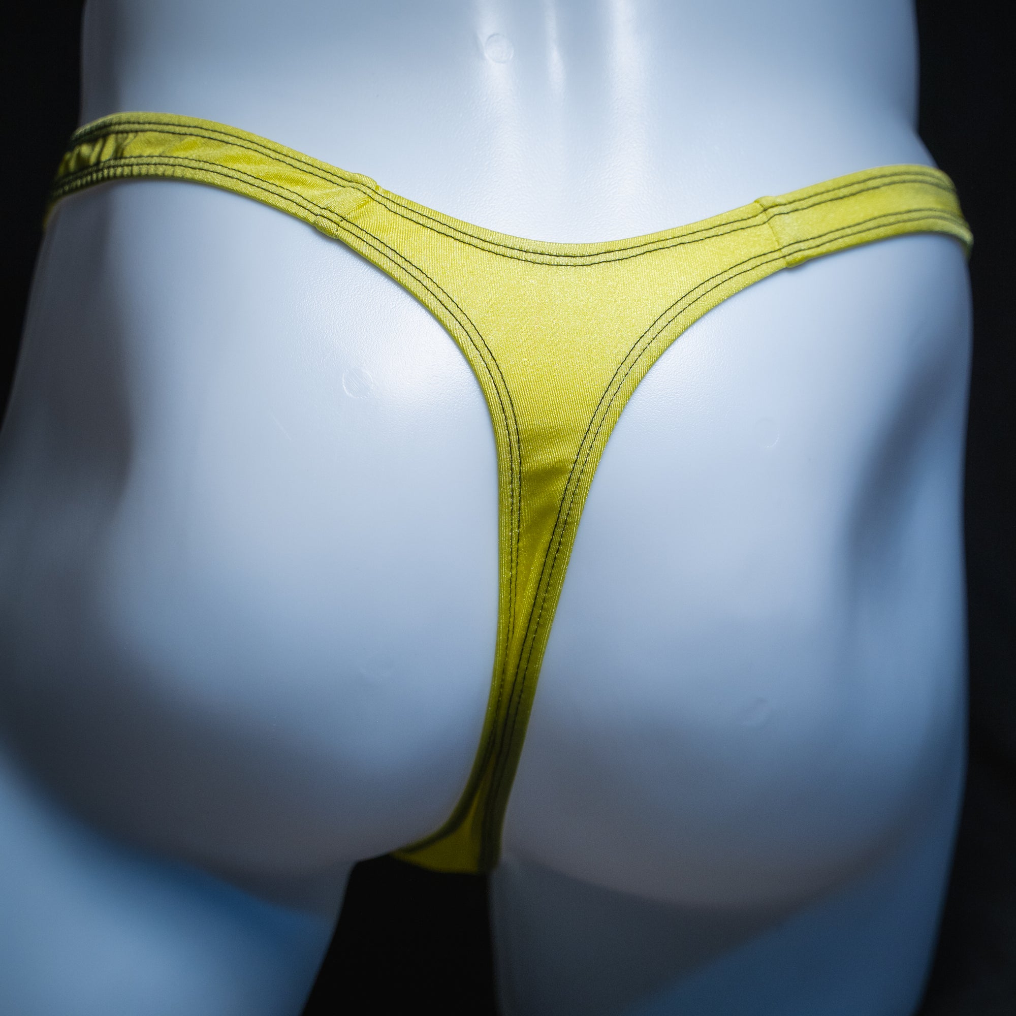 Men's neon yellow thong, slim cut, rear view.