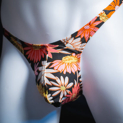 Men's floral thong, slim cut, angled front view.