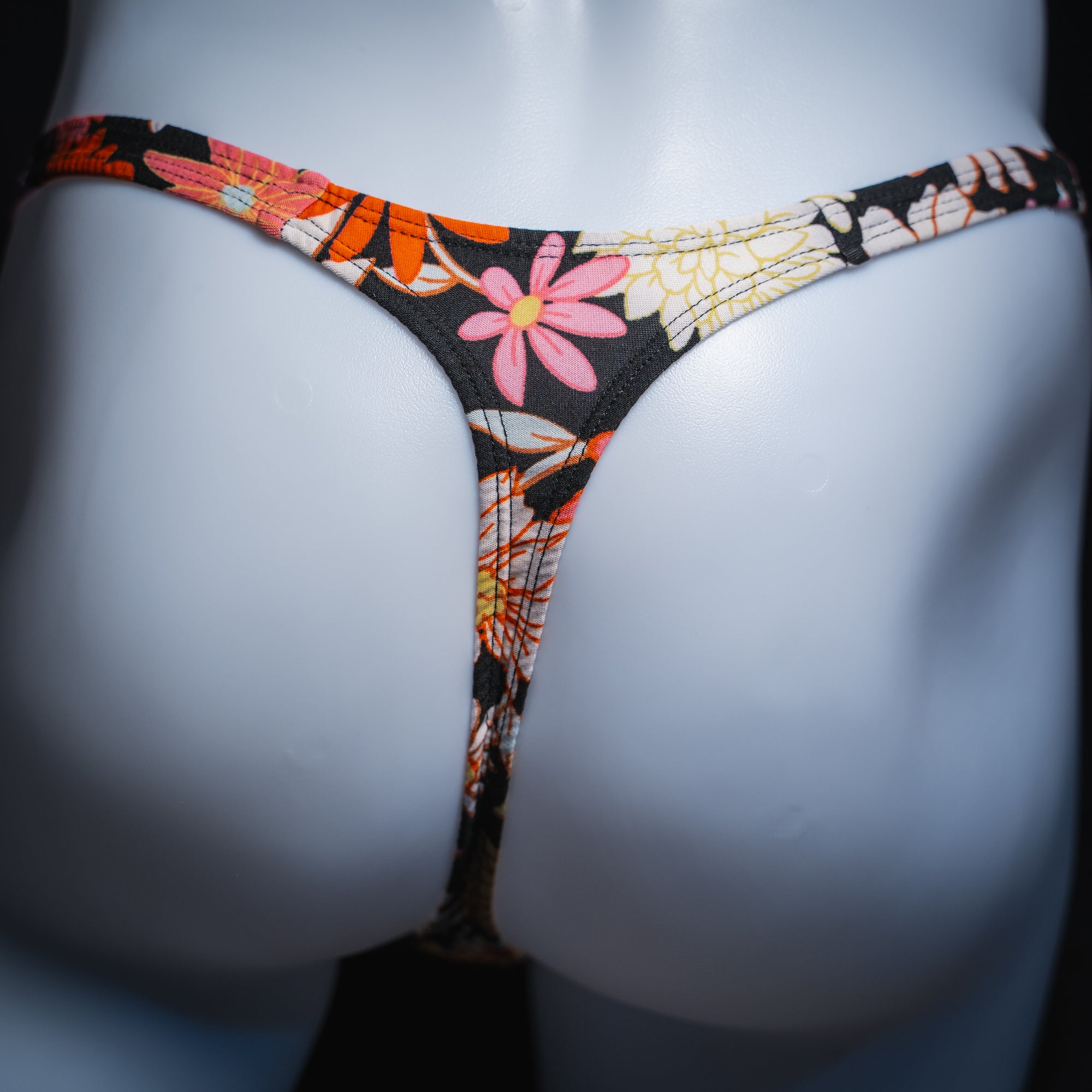 Men's floral thong, slim cut, rear view.