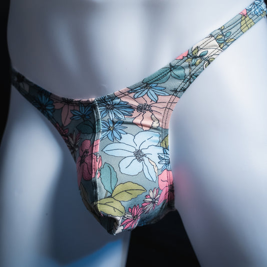Men's blue floral thong, slim cut, angled front view.
