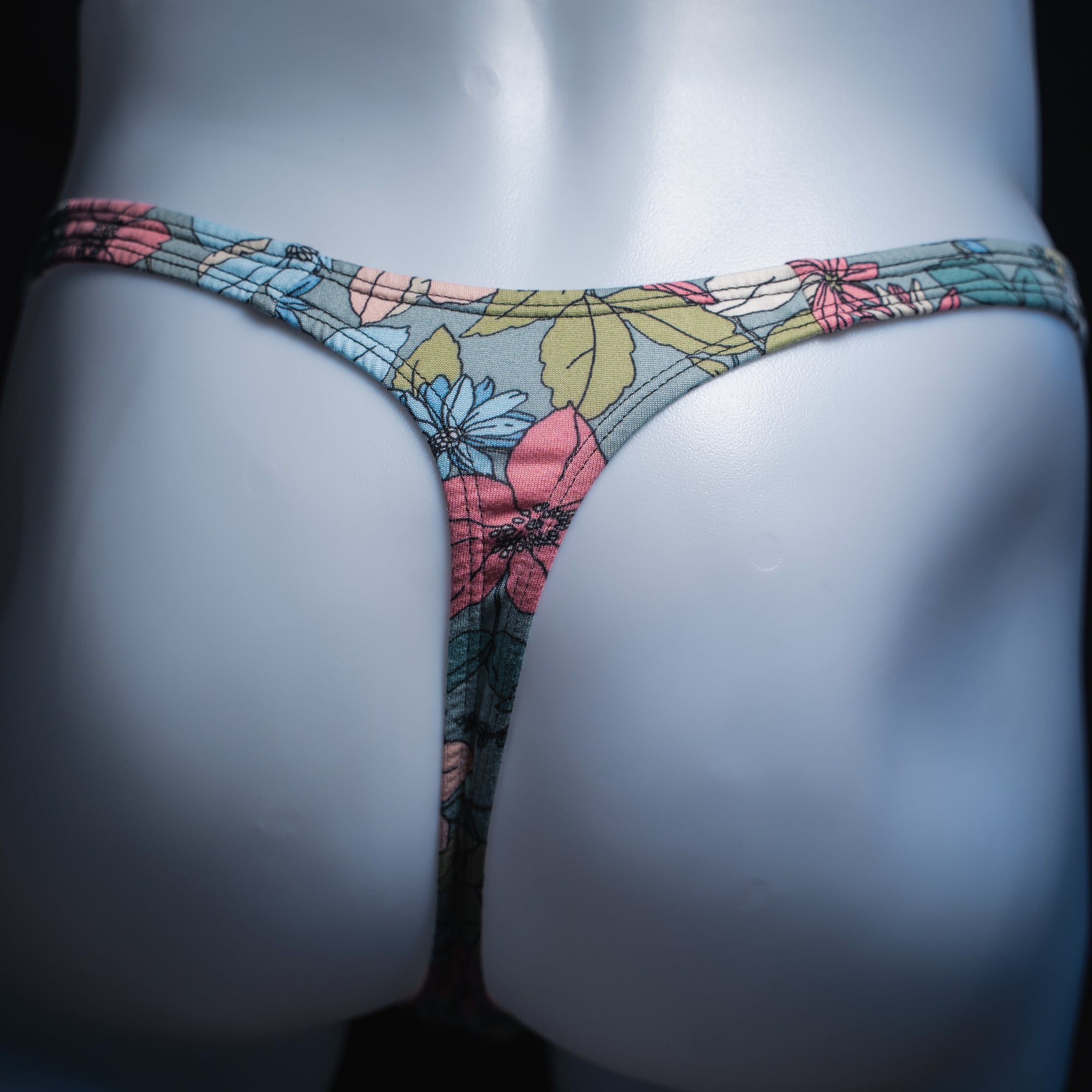 Men's blue floral thong, slim cut, rear view.