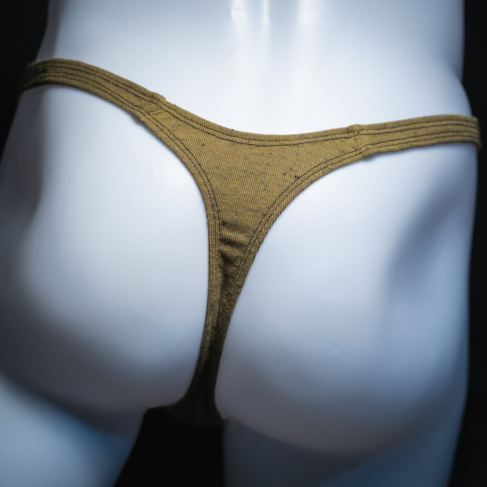 Men's soft army green thong, slim cut, rear view.