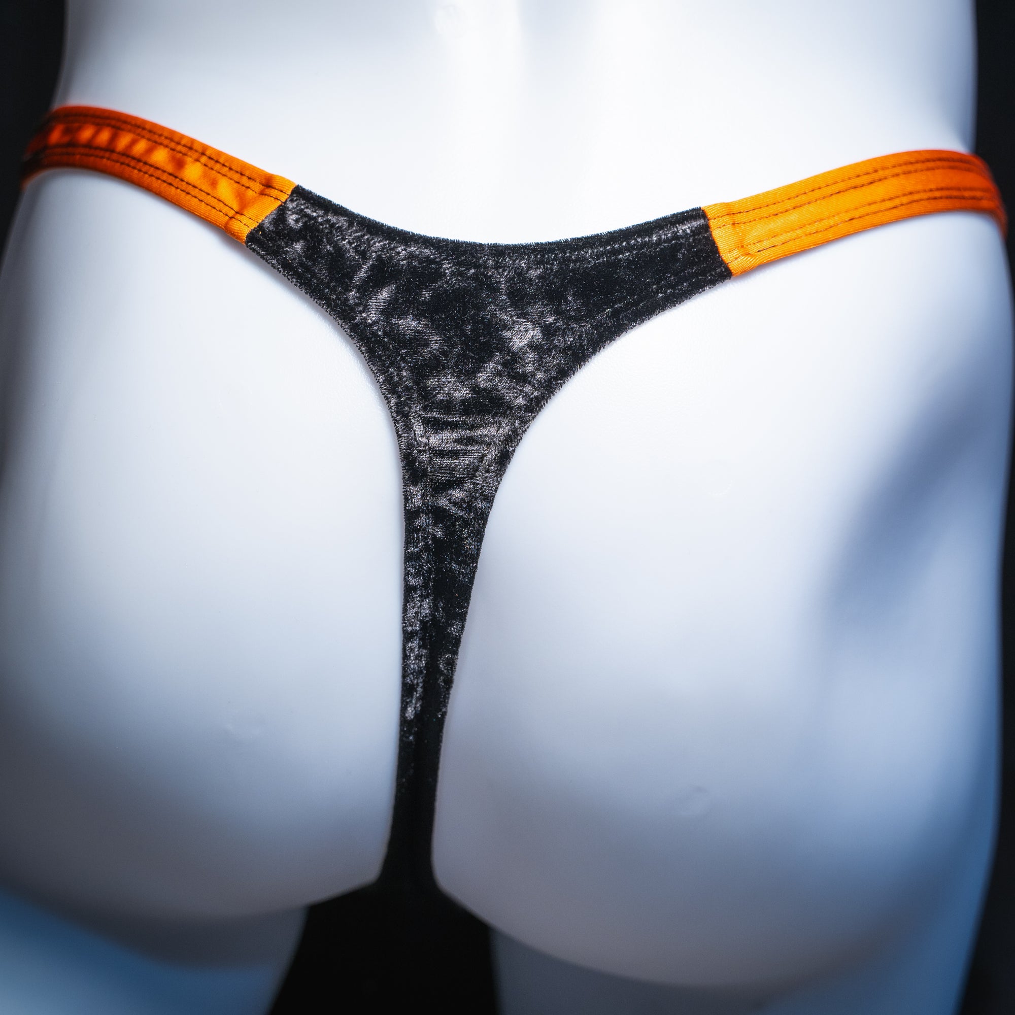 Men's velvet Halloween thong, slim cut, rear view.