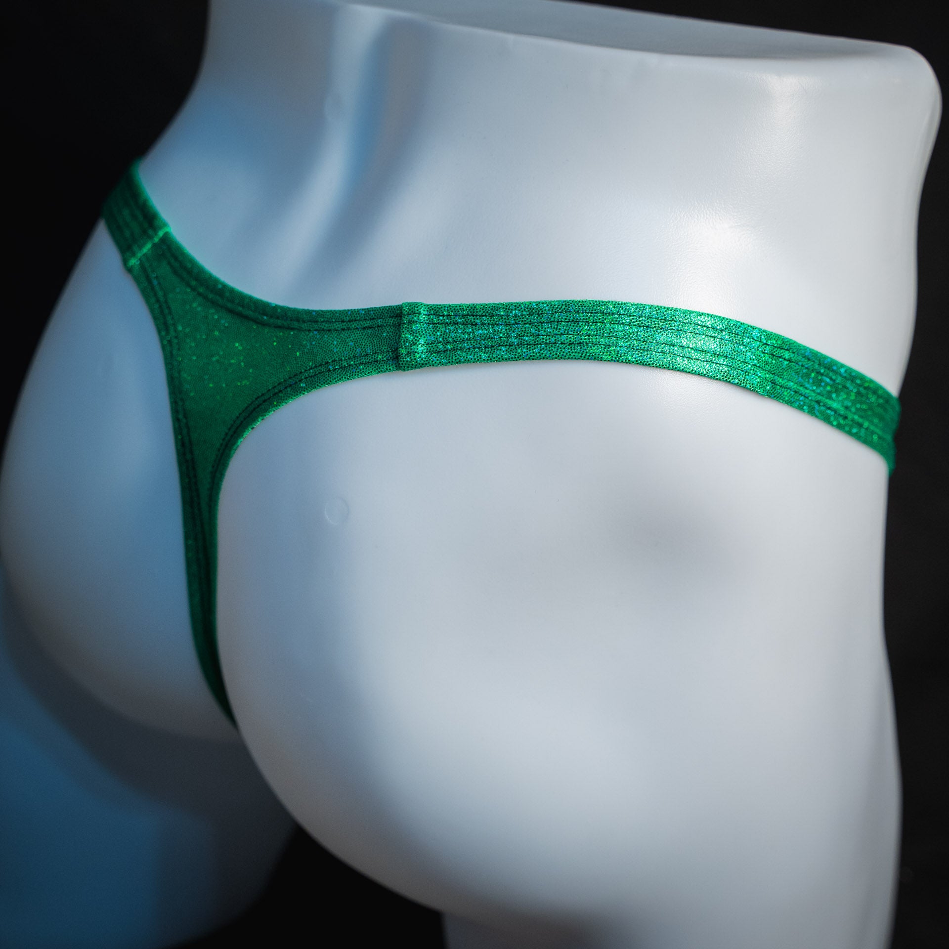 handmade mens thong underwear, green dragon metallic material, slim cut variation, angled back view