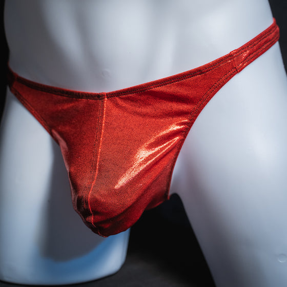 Men's metallic red thong, classic cut, angled front view.