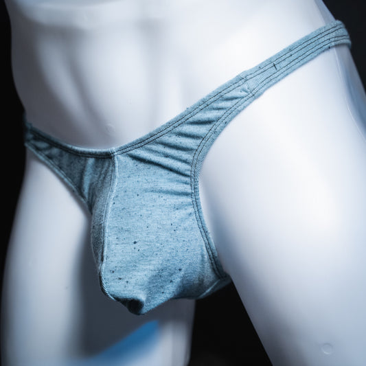 Men's soft blue thong, slim cut, angled front view.