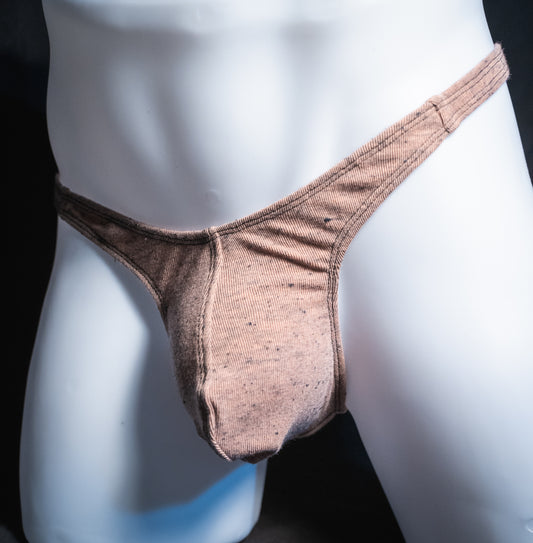 Men's soft pink thong, slim cut, angled front view.