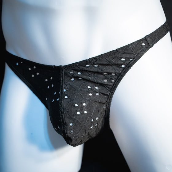 handmade mens thong underwear, solid black eyelets, soft polyester material, classic cut variation, angled front view