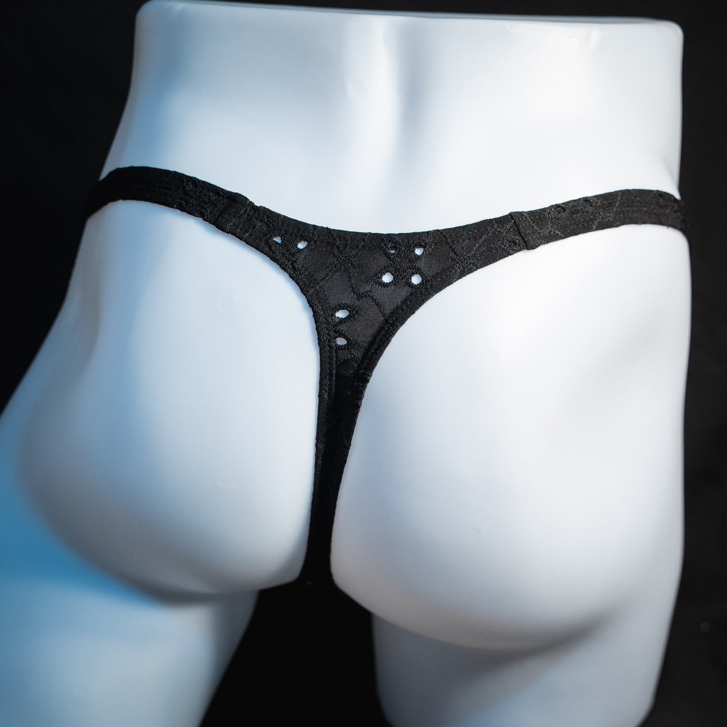 handmade mens thong underwear, solid black eyelets, soft polyester material, classic cut variation, back view