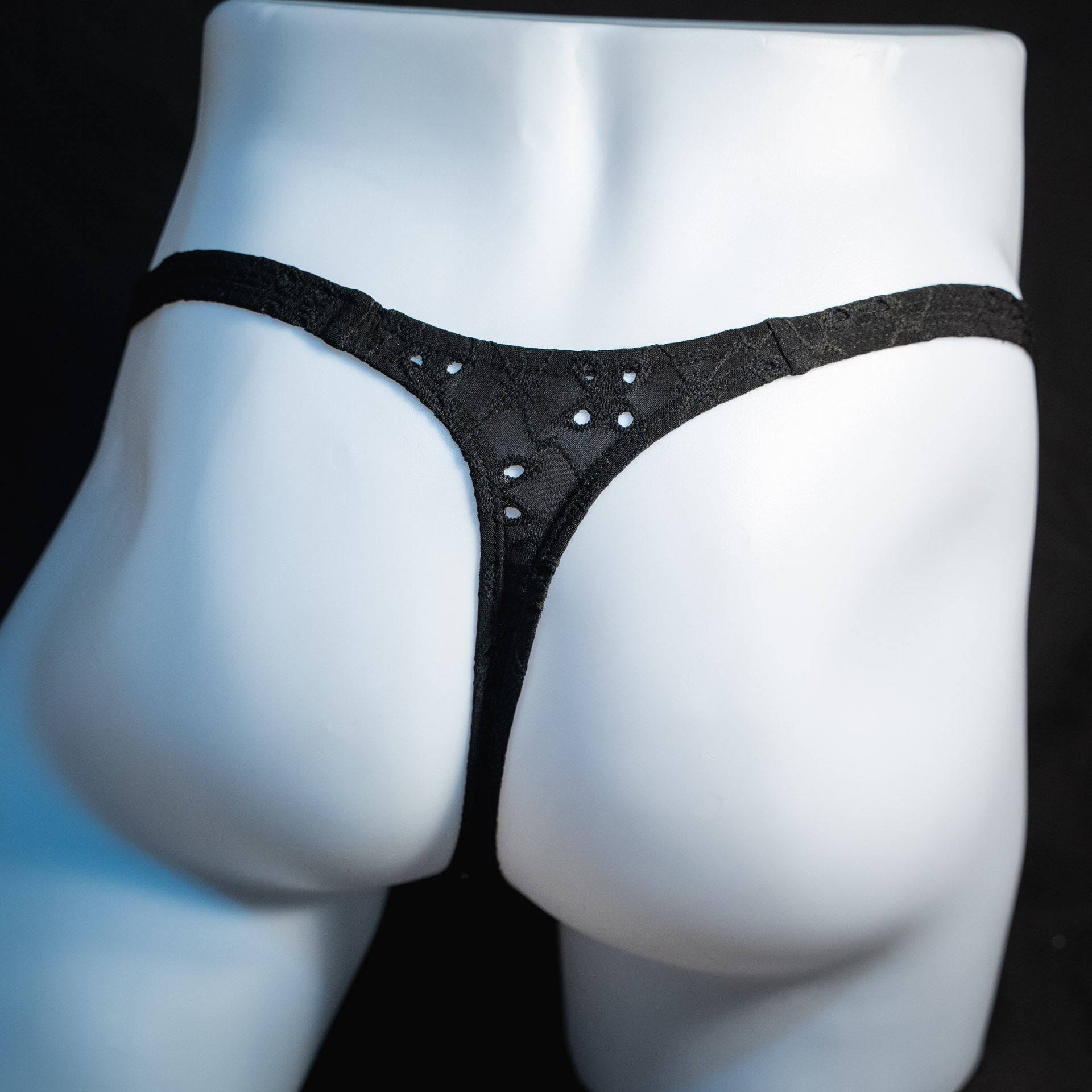 handmade mens thong underwear, solid black eyelets, soft polyester material, classic cut variation, back view