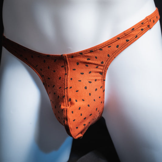 Men's red watermelon seeds thong, slim cut, front view.