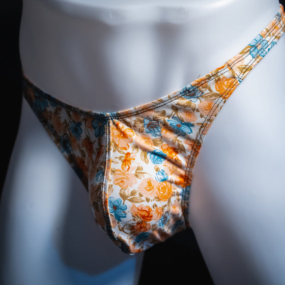 men's floral thong shown in classic cut from an angled front view