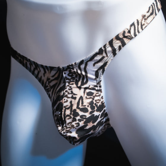 Men's white animal thong, slim cut, angled front view.