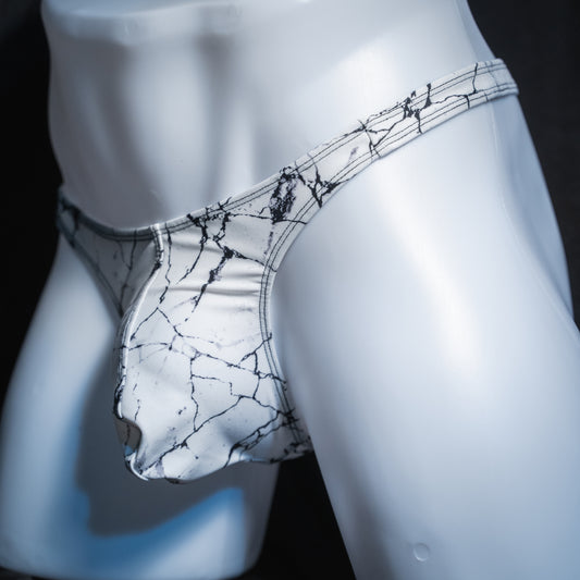 Men's white marble thong, slim cut, angled front view.